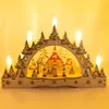 A wooden Christmas candle arch with a winter village scene inside, illuminated by LED candles. Produktbild-Vorschau