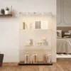 A glass display cabinet with LED lighting, showcasing various decorative items and books. Produktbild-Vorschau