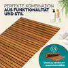 A wooden bath mat is shown in a bathroom setting with toiletries and slippers. Produktbild-Vorschau