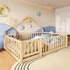 A child's bedroom with a wooden bed frame, stuffed animals, and decorative stars on the wall. Voir les images du produit
