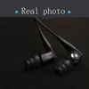 A close-up shot of two in-ear headphones on a black background. Podgląd zdjęcia produktu