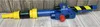A toy proton blaster is displayed on a wooden plank floor against a wooden plank wall. Anteprima dell’immagine prodotto