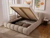 A beige upholstered bed with its storage compartment open, revealing pillows and bedding, in a well-lit bedroom setting. Produktbild-Vorschau
