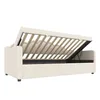 A cream-colored sofa bed with its mattress and wooden slats lifted to reveal the storage compartment underneath. Produktbild-Vorschau
