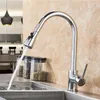 A kitchen sink with a chrome faucet running water into it. There are storage jars in the background. Náhľad obrázku produktu