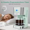 A woman sleeping peacefully next to a coffee maker, implying the coffee maker can prepare coffee for her wake-up. Produktbild-Vorschau