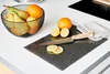 A cutting board with a knife and lemons on a kitchen counter. Náhled obrázku produktu