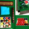 A collage of images showing various billiard accessories and parts of a billiard table. Produktbild-Vorschau