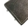 A close-up, angled view of a rectangular charcoal filter with a dark grey, fibrous surface and a raised border. The background is white. Voir les images du produit