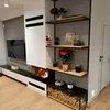 A modern living room with a fireplace and shelving unit. Anteprima dell’immagine prodotto