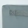 A close-up view of a gray fabric storage cube with a fabric handle attached. Podgląd zdjęcia produktu