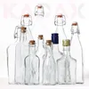 A collection of various glass bottles with different closures and sizes, arranged on a white background. Anteprima dell’immagine prodotto