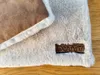 A close-up view of a soft, furry dog mat with a brown label that says "DOTTY". Produktbild-Vorschau