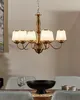 A chandelier hangs above a dining table set with chairs, a bowl, and cups. Náhled obrázku produktu