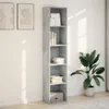 A tall, narrow bookshelf with a concrete-gray finish stands against a white wall, with two framed pictures on the wall to its left and a potted plant to its right. Produktbild-Vorschau