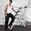 A man in work clothes is climbing a multi-purpose ladder against a distressed concrete wall. Náhľad obrázku produktu