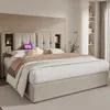 A bedroom scene featuring a bed with a headboard that has built-in shelves and a tablet. Produktbild-Vorschau