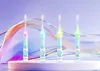 Four electric toothbrushes with cartoon lion designs and colored lights are displayed on a white platform against a purple and abstract background. Produktbild-Vorschau
