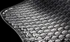 A close-up of a black honeycomb-patterned car floor mat with water droplets. Produktbild-Vorschau
