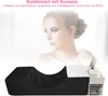 A woman's face is blurred in the background, with a black eyelash pillow and organizer in the foreground. Produktbild-Vorschau