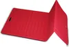 A red folding mat is shown from a diagonal angle. Podgląd zdjęcia produktu