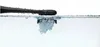 A close-up shot of a black electric toothbrush head partially submerged in water, creating bubbles. Podgląd zdjęcia produktu