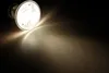 A spotlight shines down on a surface, creating a bright pool of light. Produktbild-Vorschau