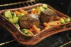 A roasting pan with food inside an oven. Podgląd zdjęcia produktu