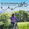 A woman is riding a bicycle in a scenic outdoor setting with trees and hills in the background. Text overlays provide information about the bike's range. Produktbild-Vorschau