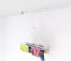 A ceiling-mounted clothes drying rack with laundry hanging on it, set against a white background. Náhľad obrázku produktu