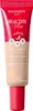 A product shot of a tube of foundation with a red cap. Podgląd zdjęcia produktu