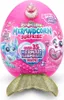 A pink egg-shaped toy package with a gold mermaid tail accessory attached to the bottom. Náhľad obrázku produktu
