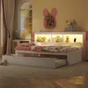 A child's bedroom with a daybed and trundle, decorated with stuffed animals and a bunny-shaped shelf.