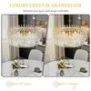 A split image showing a luxury crystal chandelier in two different lighting conditions, with a dining table and chairs in the foreground. Produktbild-Vorschau