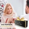 A woman receives a gift from a man in a festive setting. Produktbild-Vorschau