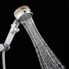 A close-up shot of a chrome shower head with water spraying out, against a black background. Produktbild-Vorschau