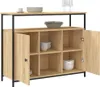 A wooden sideboard with black metal legs, displaying various bowls and plates on its shelves and top surface. Náhľad obrázku produktu