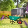 A person is working in a garden near a shed, with a wheelbarrow full of logs in the foreground. Produktbild-Vorschau