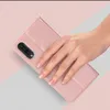A hand is holding a pink phone case with a phone inside. Produktbild-Vorschau