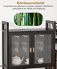 Close-up of a black cabinet with glass doors, showcasing teacups and a teapot inside, with an overlay image of bamboo stalks and text highlighting 'Bambusmaterial'. Anteprima dell’immagine prodotto