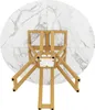 The underside of a round dining table with a marble-effect top and golden legs, viewed from directly above. Voir les images du produit