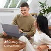 A couple is sitting on a couch, looking at a laptop. Produktbild-Vorschau
