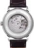 The back of a watch with an open case showing the internal movement and branding. Produktbild-Vorschau