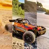 A collage of four images showing an RC car in different environments: sand, mud, gravel, and a paved road. Anteprima dell’immagine prodotto