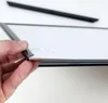 A hand is shown holding the edge of a black picture frame, demonstrating how to insert or remove something from it. Produktbild-Vorschau