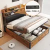 A bed with storage, featuring a headboard with shelves and integrated USB ports, shown in a bedroom setting. Produktbild-Vorschau