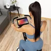 A woman is using a stationary exercise bike in a home gym setting. Náhľad obrázku produktu