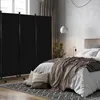 A bedroom scene with a black room divider set up to partition the space. Voir les images du produit