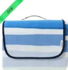 A folded picnic blanket with blue and white stripes. Náhled obrázku produktu