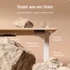 A desk with rocks and a glass of water, highlighting stability. Voir les images du produit